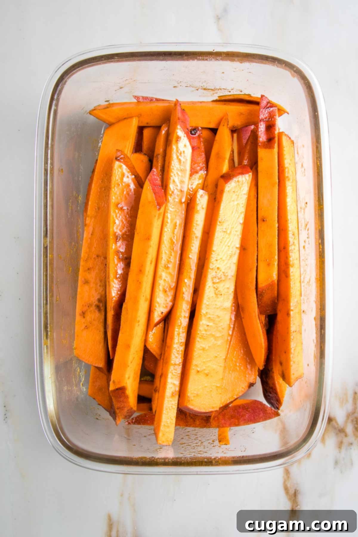 Sweet potatoes cut into fries, tossed in oil and spices.