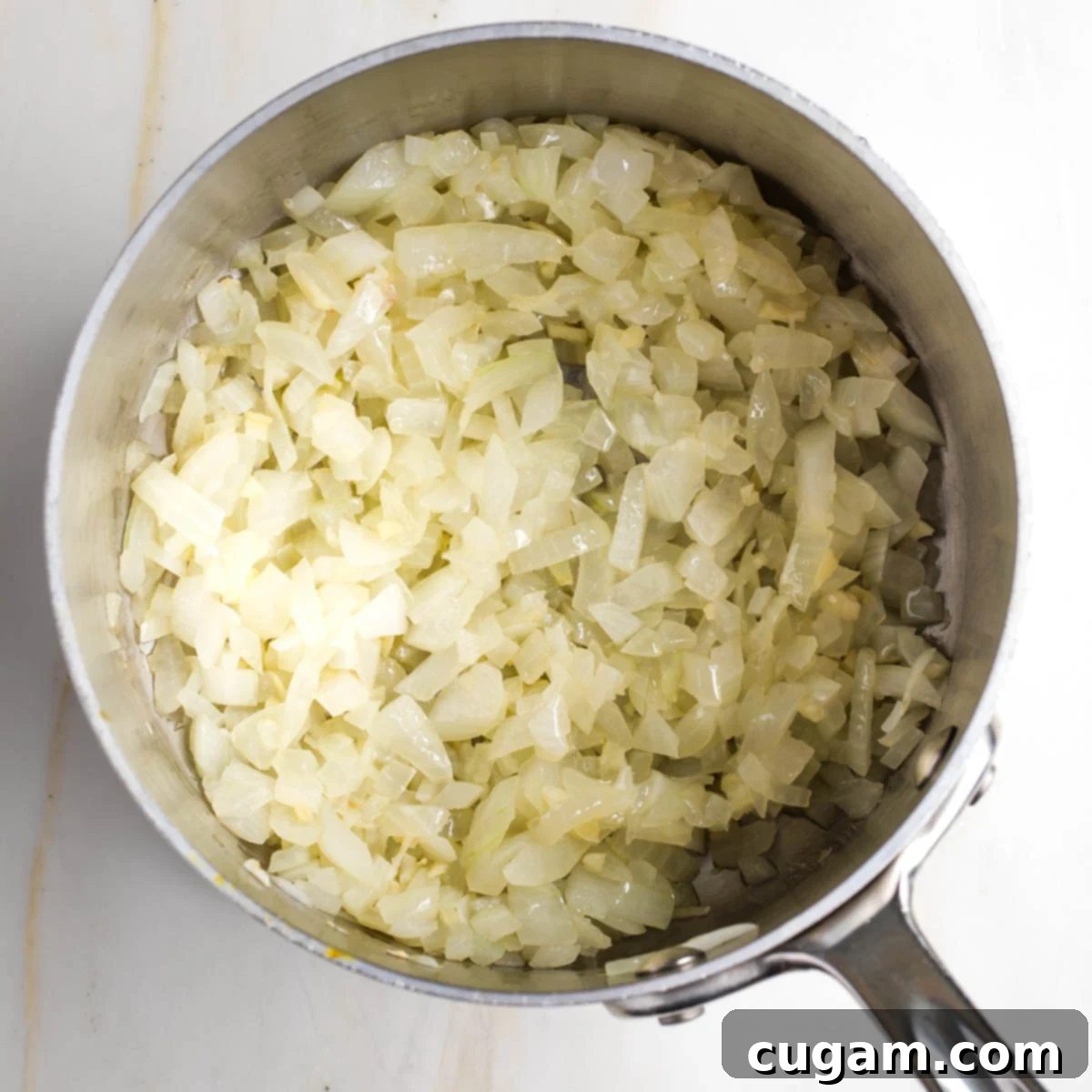 Sauteed diced onion and garlic in a small saucepan.