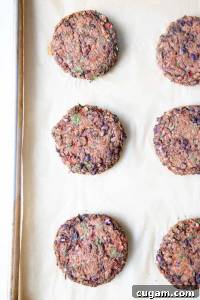 Cooked Veggie Burgers on a baking tray lined with parchment paper.