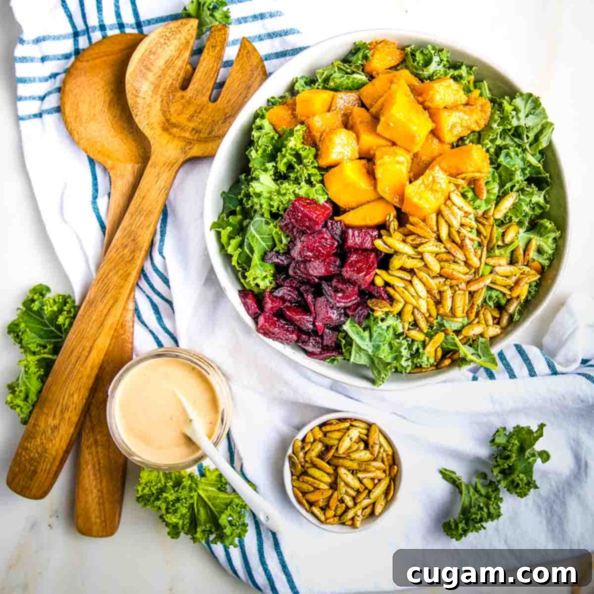 Roasted butternut squash and beets on top of kale plus creamy dressing and toasted pumpkin seeds.