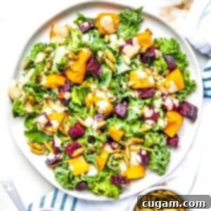 Kale salad with roasted squash and beets. Toasted pumpkin seeds and a creamy dressing complete the salad.