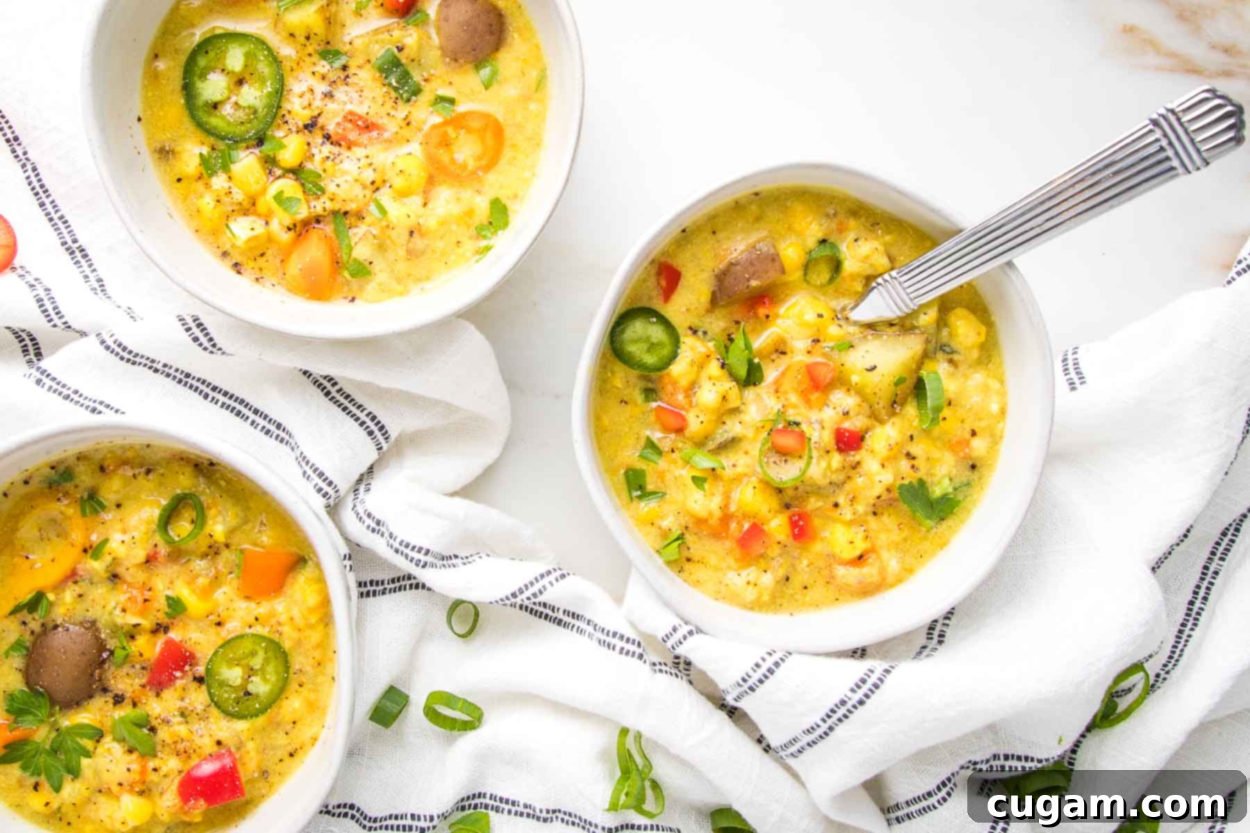 white bowls filled with chunky, colorful corn chowder