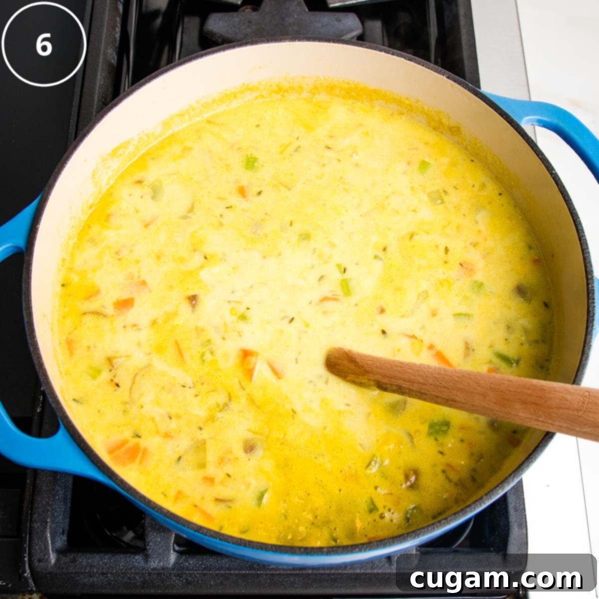 Step 6: Add almond milk to the yellow broth with chunks of vegetables. 