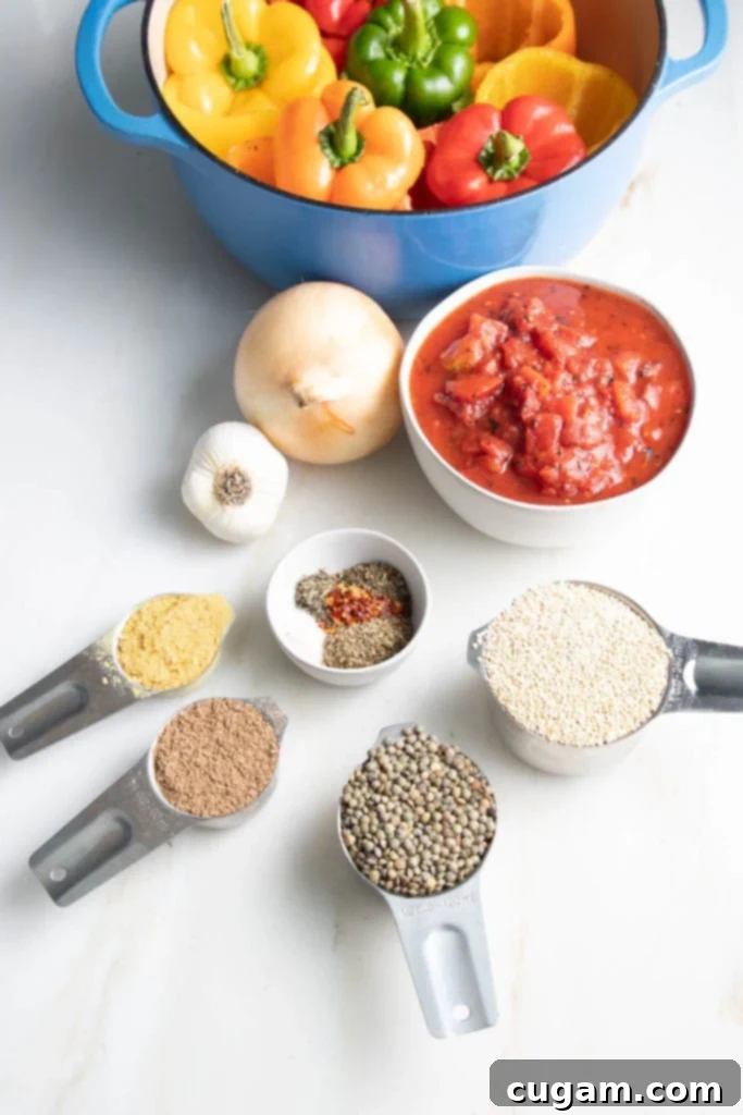 Ingredients for vegan stuffed peppers: colorful bell peppers, diced tomatoes, quinoa, lentils, onions, garlic, Italian spices, ground flax, and nutritional yeast, laid out on a wooden surface.