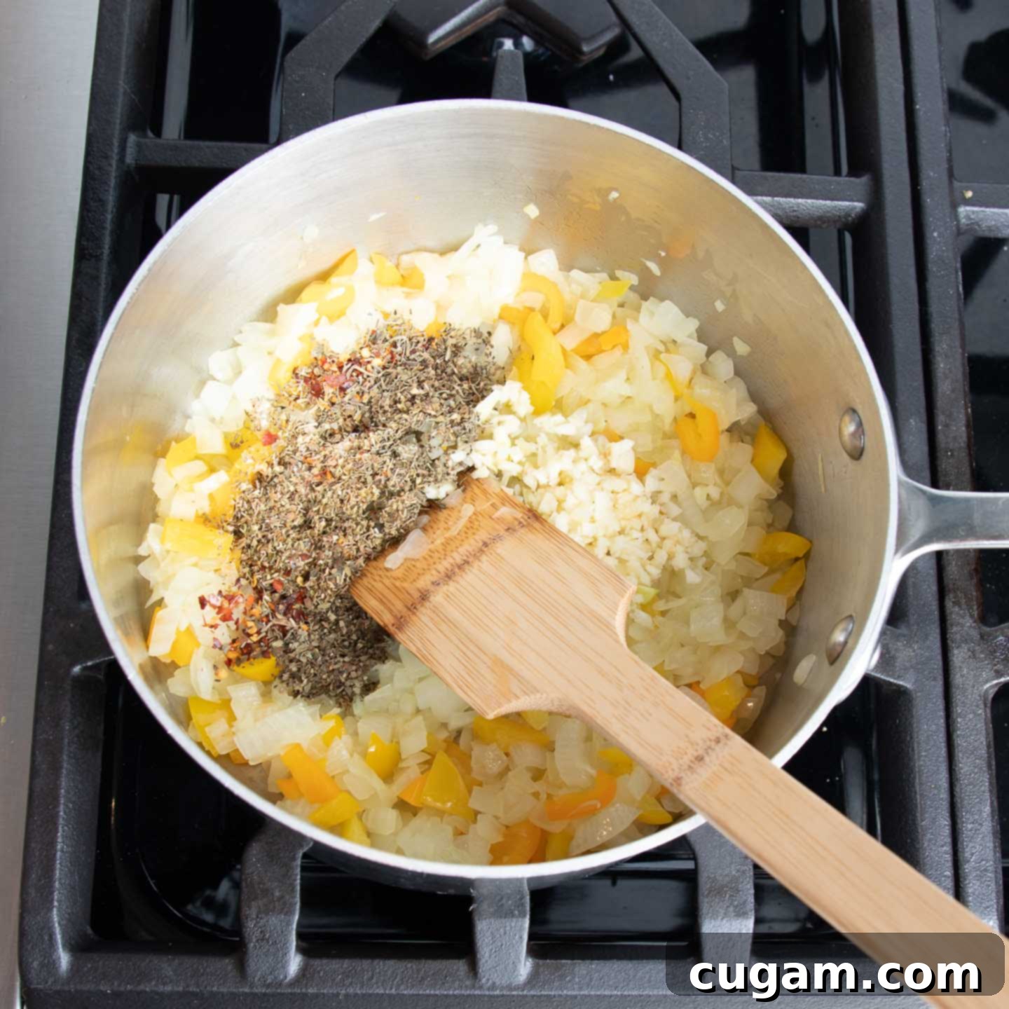 Onions and bell pepper scraps being sautéed in a skillet, filling the kitchen with aromatic scents.