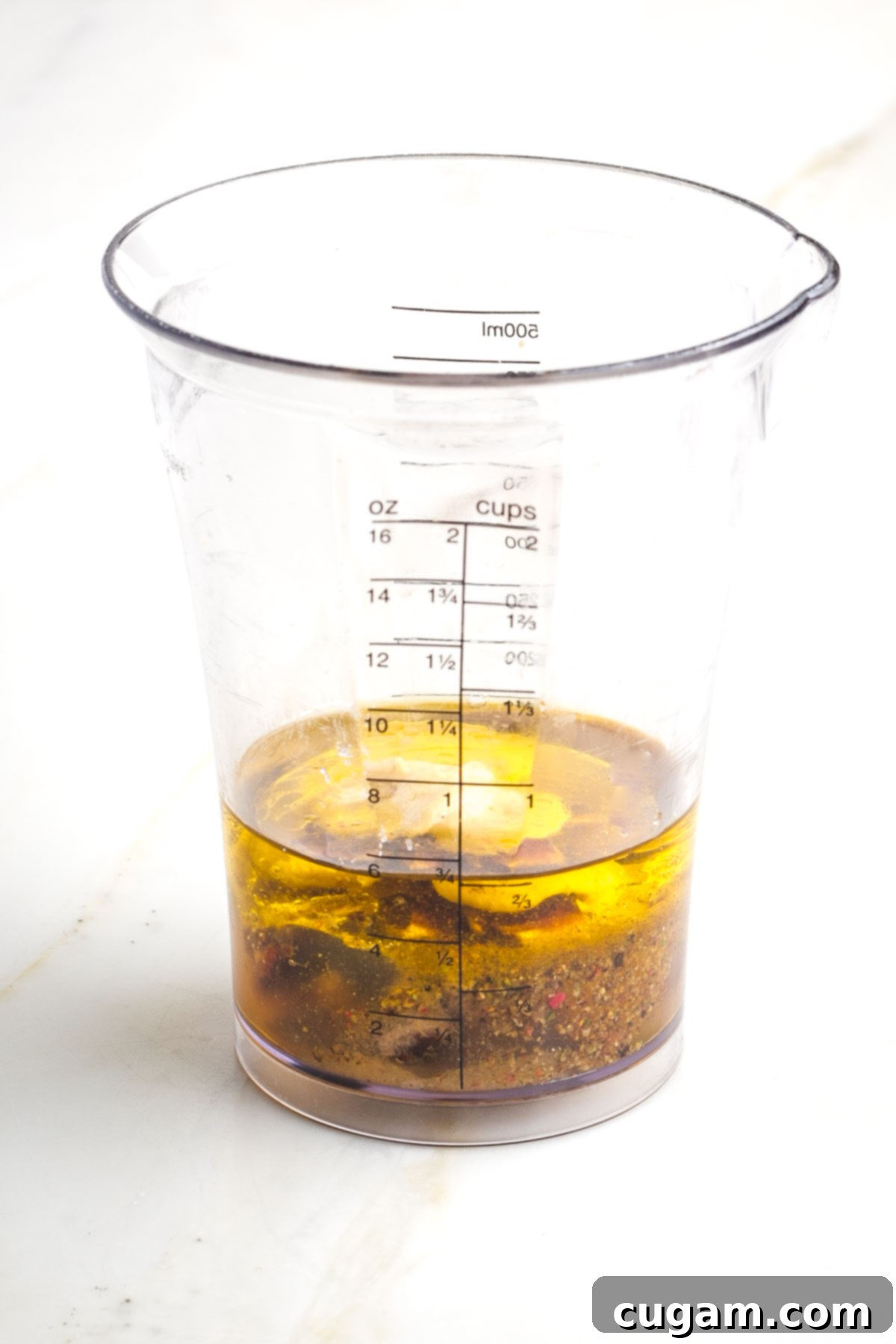 Blender cup with oil, vinegar, spices, mustard. 