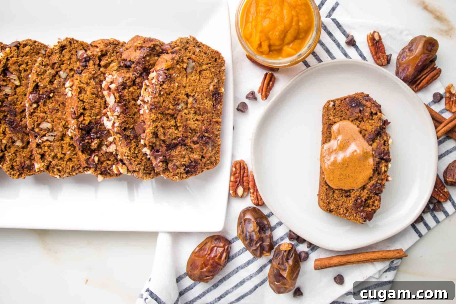 Slices of pumpkin bread with one slice on a plate with peanut butter.