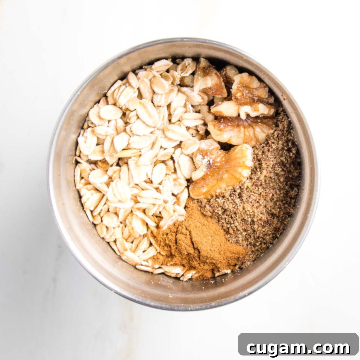 Oats, walnuts and spices in a spice grinder.