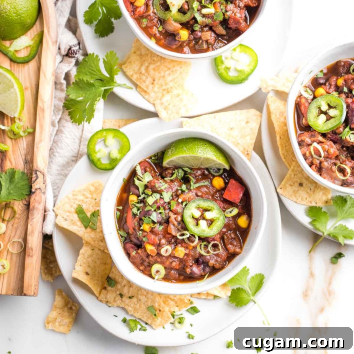 Quick and Easy Vegan Lentil Chili 11 Lots of toppings for vegan chili: lime wedges, sliced jalapenos, fresh cilantro and corn chips.