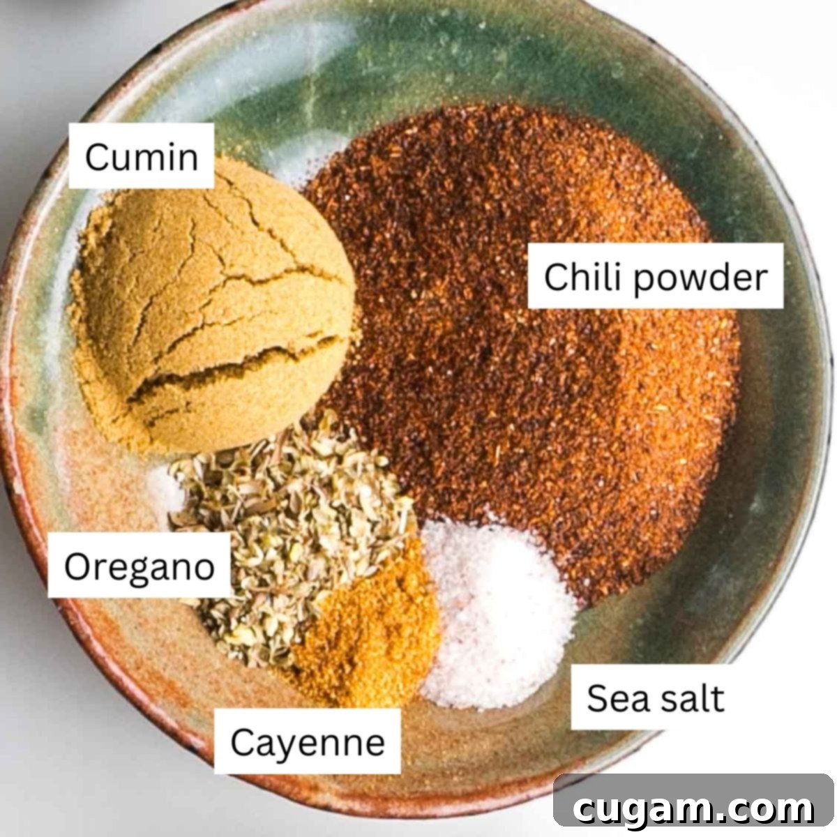 Quick and Easy Vegan Lentil Chili 7 Labeled spices for chili: cumin, chili powder, oregano, cayenne, sea salt.