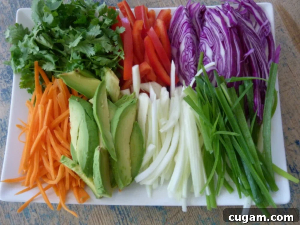 Crisp Veggie Spring Rolls with Creamy Peanut Sauce 19 A tray of colorful julienned vegetables are ready to wrap.