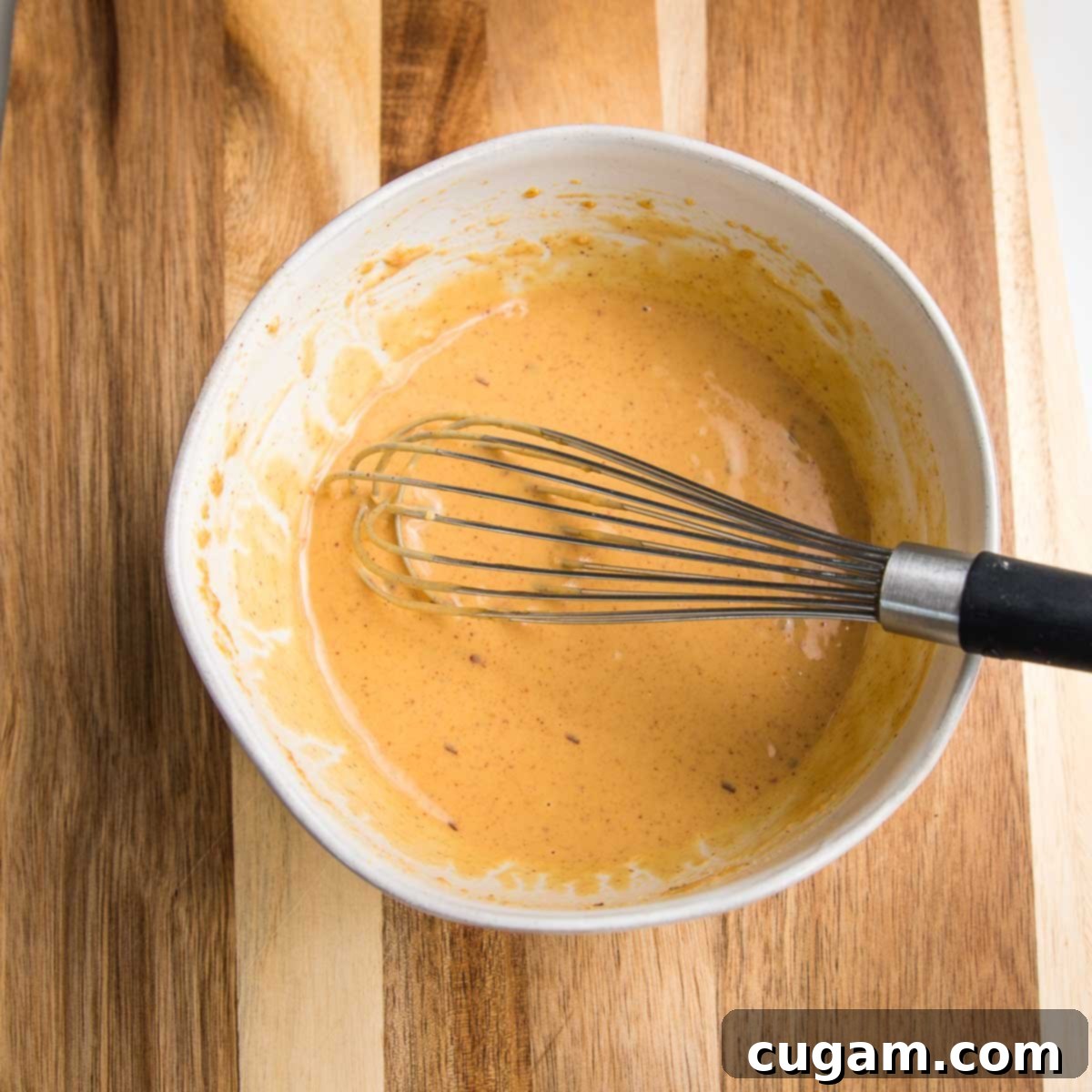 Crisp Veggie Spring Rolls with Creamy Peanut Sauce 7 White bowl with peanut sauce being whisked.