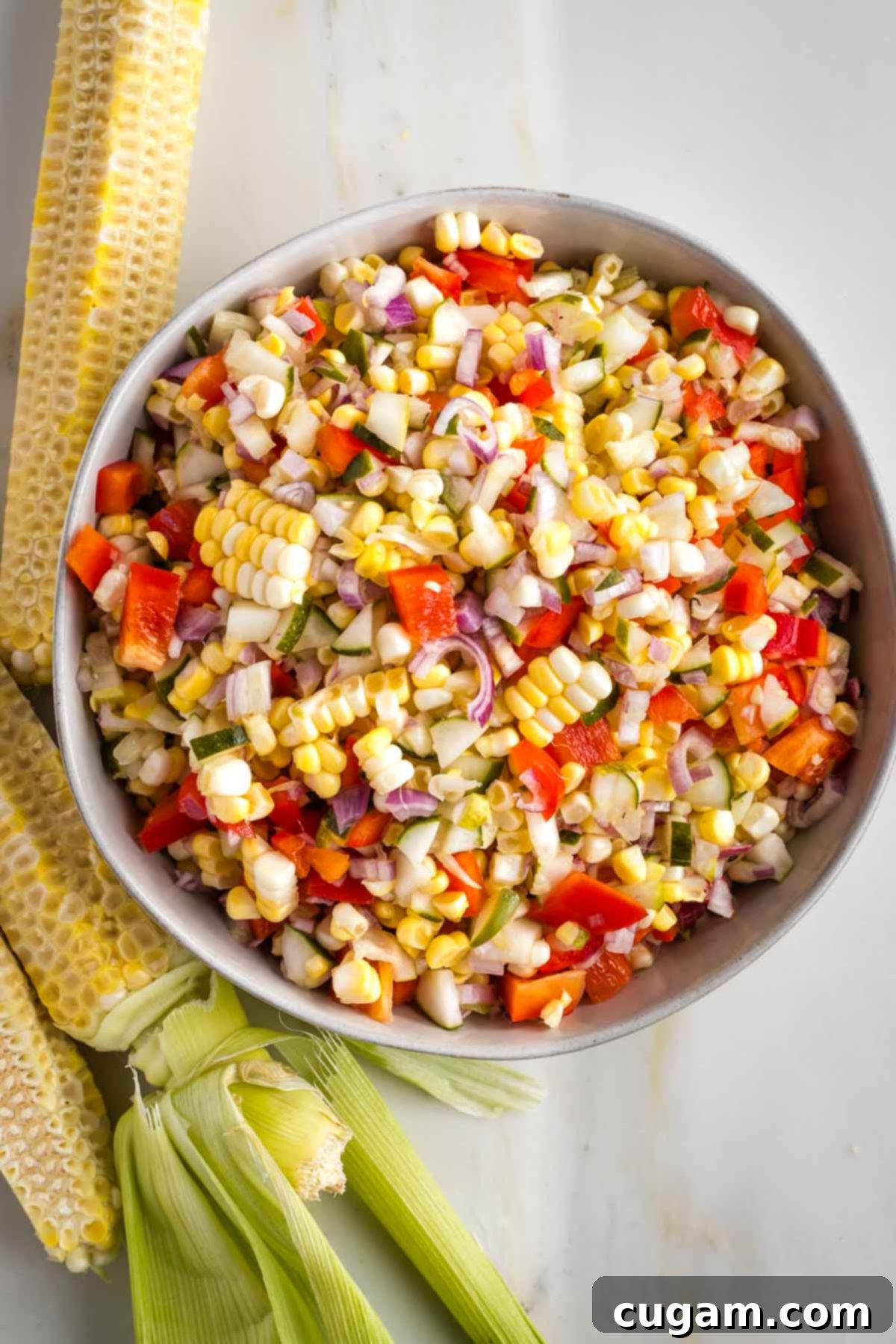 Israeli Corn and Pickle Salad 2 Corn kernels cut off the cob mixed with vibrant diced pickles, red bell peppers, and shallots, creating a colorful and fresh Israeli corn and pickle salad.