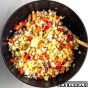 Israeli Corn and Pickle Salad 11 A colorful array of chopped pickles, vibrant red peppers, thinly sliced purple onions, and golden corn kernels, ready for an Israeli corn salad.
