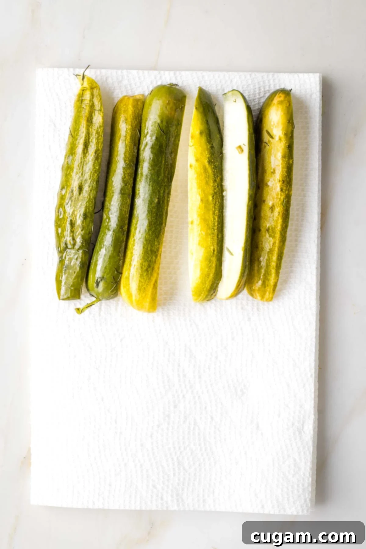 Israeli Corn and Pickle Salad 4 Several pickle spears neatly laid out on a double layer of paper towels, allowing excess moisture to drain off before dicing for a corn salad.