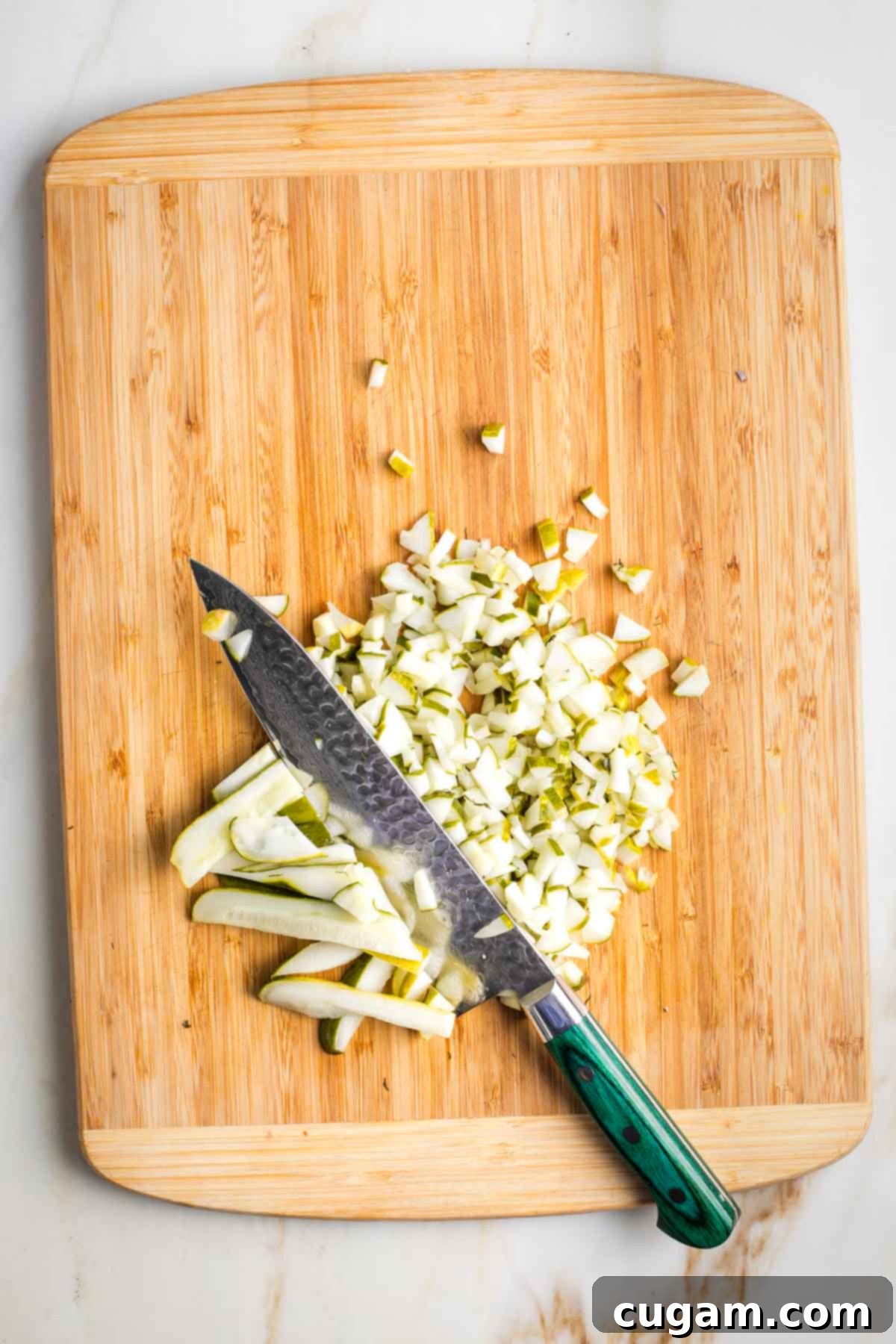 Israeli Corn and Pickle Salad 8 Drained pickle slices neatly lined up on a cutting board, ready to be chopped into small, uniform dice, matching the size of corn kernels.