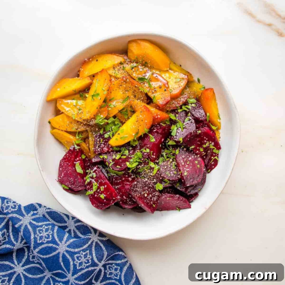 Roasted golden and red beets, cut into wedges, sprinkled with fresh parsley.