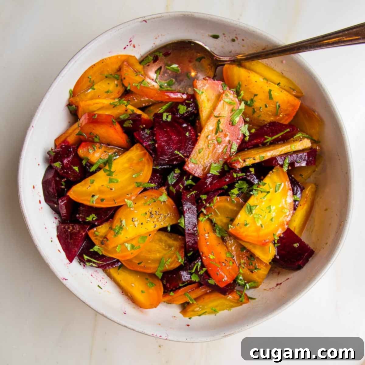 Whole roasted beet salad. Golden and red beets cut into wedges, drizzled with oil and vinegar and sprinkled with fresh parsley.
