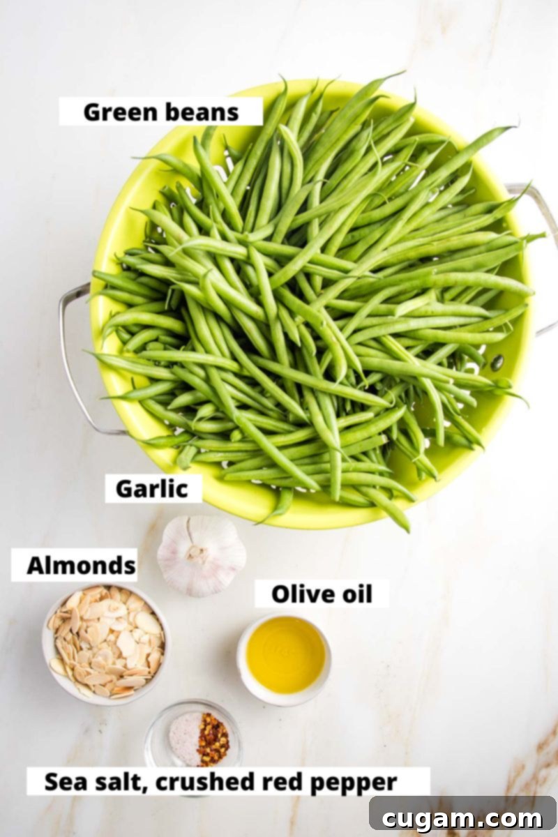 Effortless Green Beans with Toasted Almonds 4 Colander of green beans, and small dishes of garlic, almonds, olive oil and spices. All are labeled.