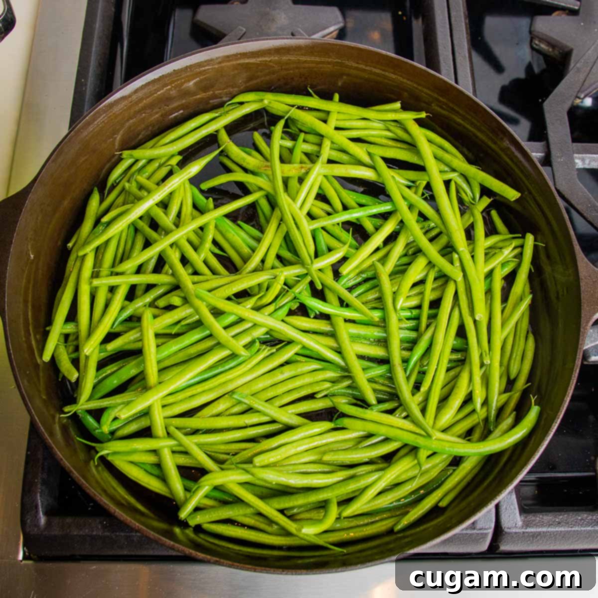 Effortless Green Beans with Toasted Almonds 7 Cast iron pan filled with green beans.