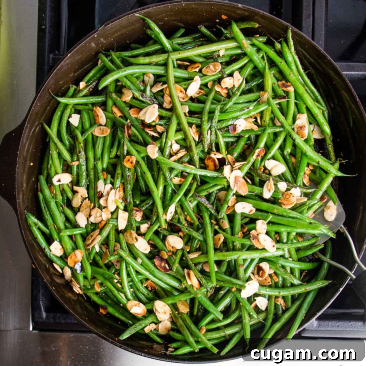Effortless Green Beans with Toasted Almonds 9 Cast iron skillet with green beans, almonds, garlic and crushed red pepper.