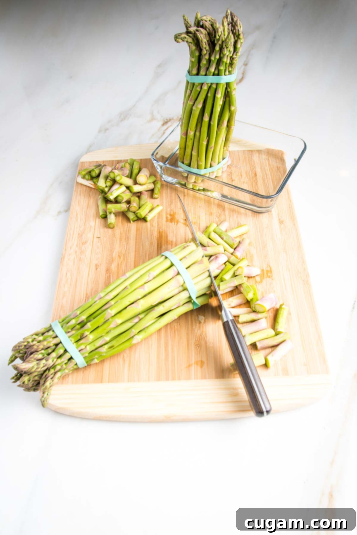 Close-up of fresh, vibrant green asparagus stalks, showing their firm texture and tightly closed tips, indicating peak freshness.