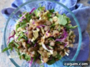 Lentil Salad with Creamy Miso Dressing, garnished with fresh herbs and a drizzle of dressing.