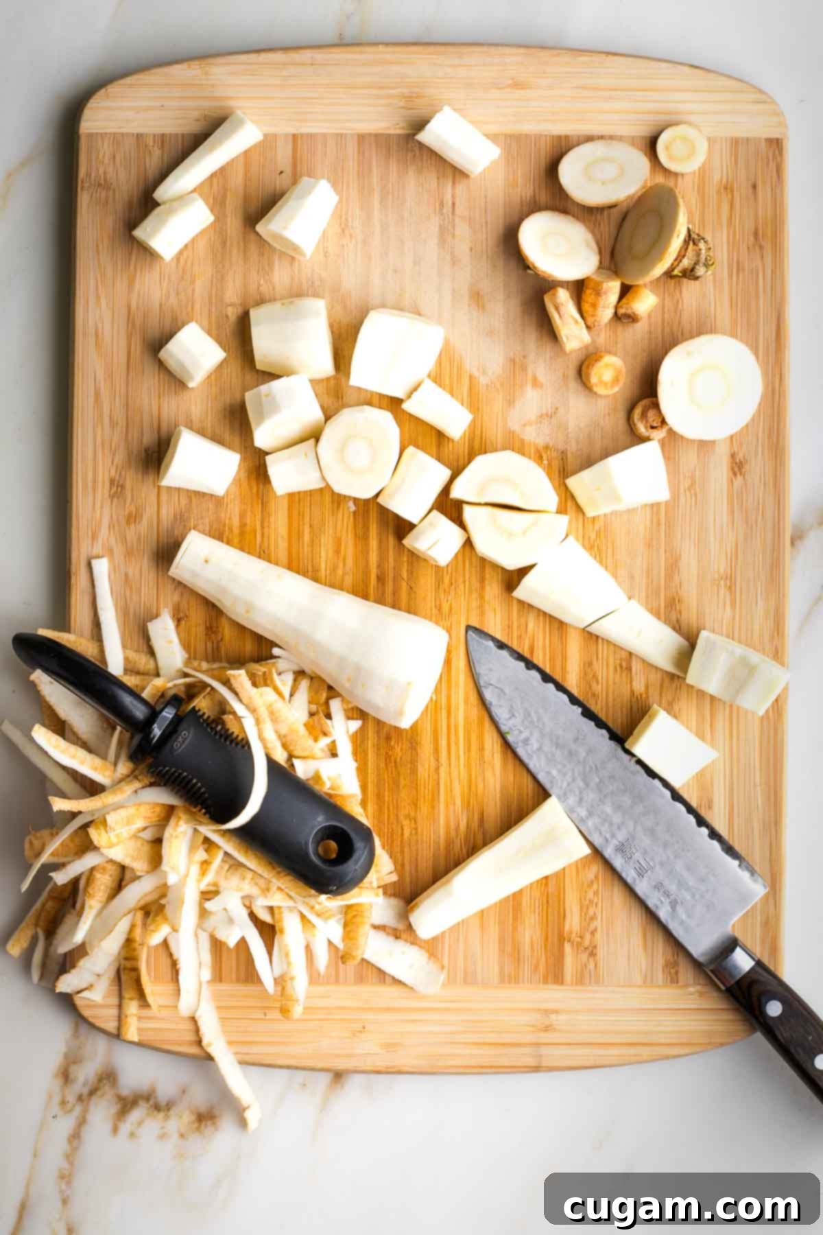 Parsnips, trimmed and peeled, being cut into small cubes.