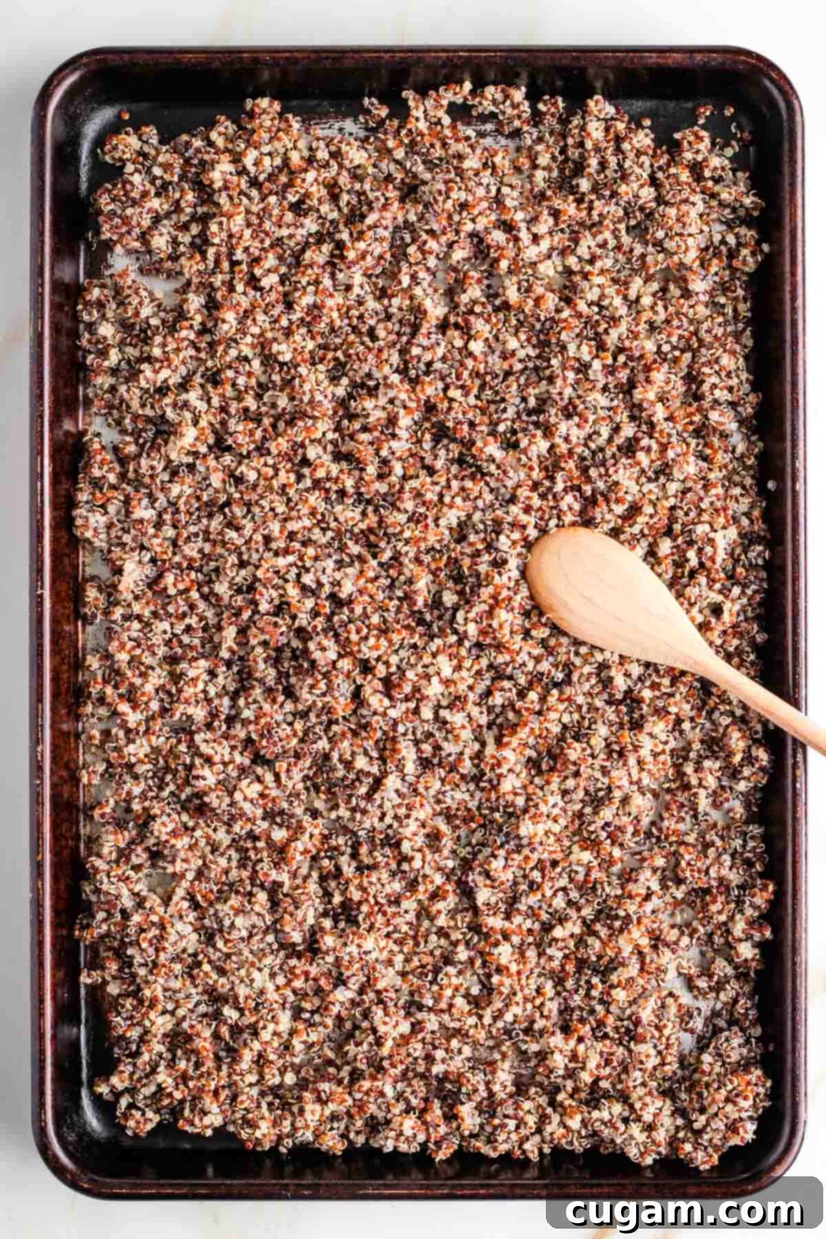 Plant-Powered Tofu Quinoa Stir-Fry 5 Large rimmed baking sheet spread with cooked quinoa, cooling evenly for perfect fried quinoa texture.