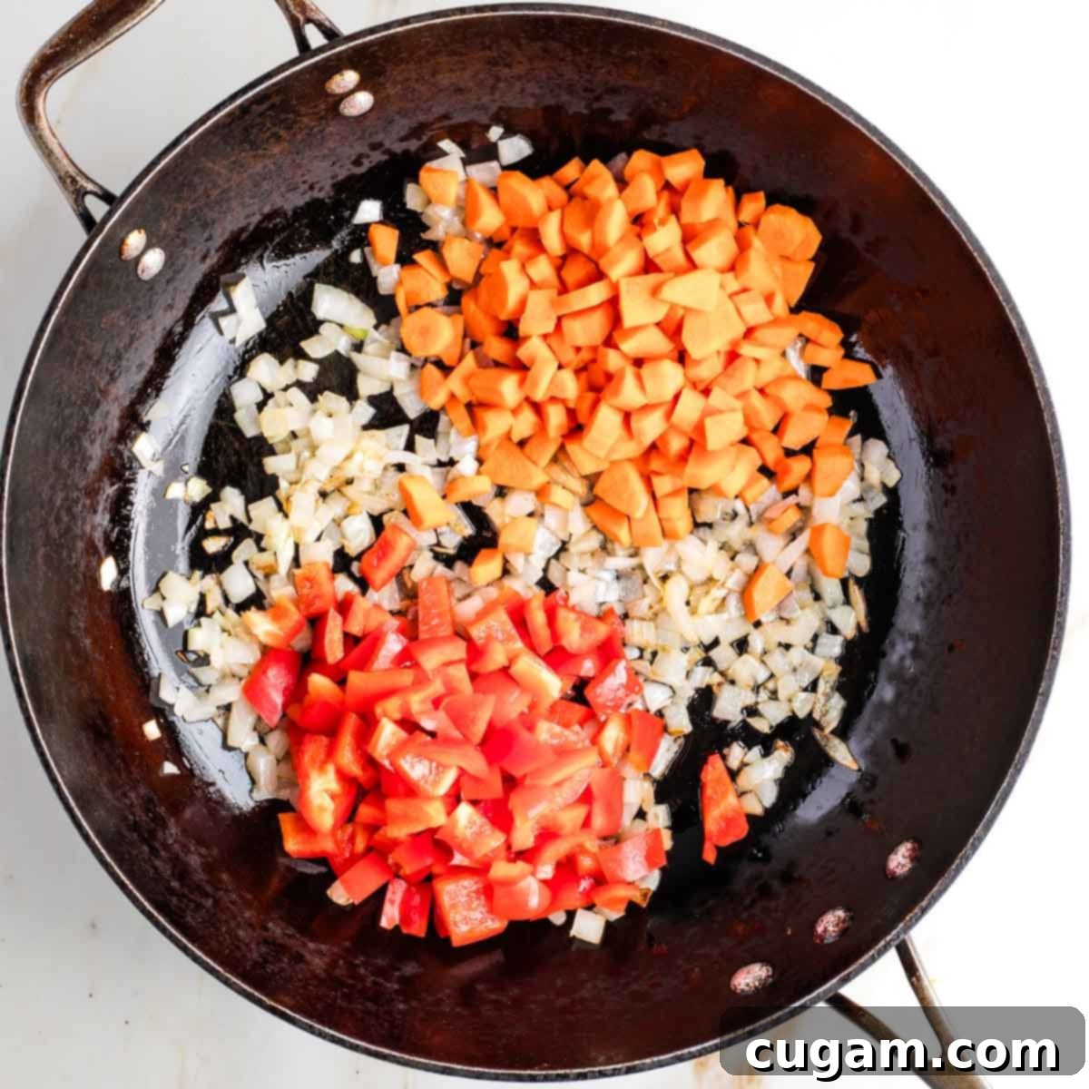Plant-Powered Tofu Quinoa Stir-Fry 8 Sauteed diced onions with red bell peppers and carrots simmering in a hot wok, building foundational flavors.