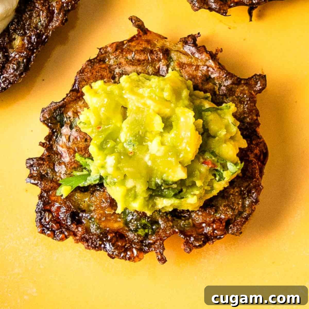 Crispy latke topped with guacamole.