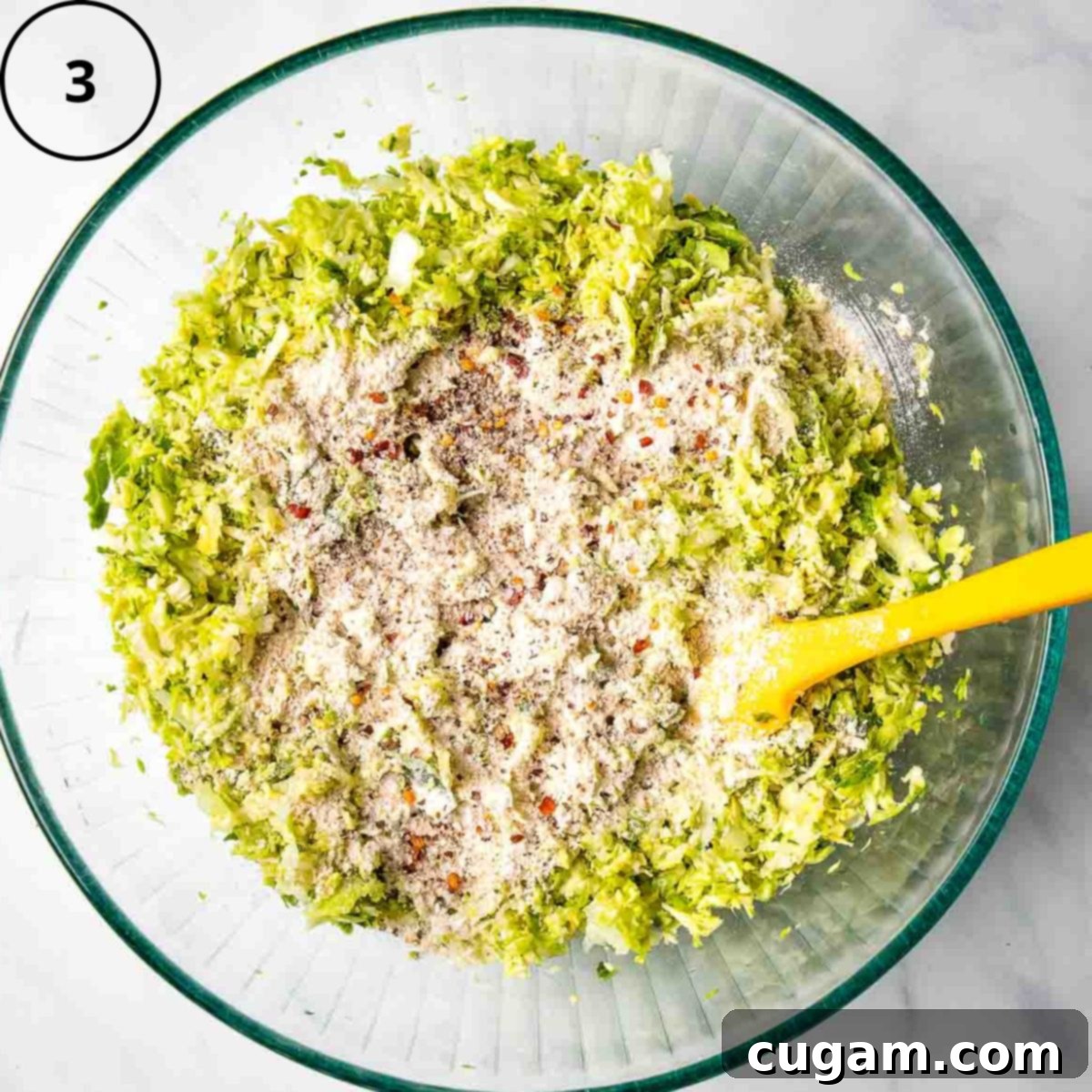 Shredded brussels sprouts and onions topped with oat flour and spices.