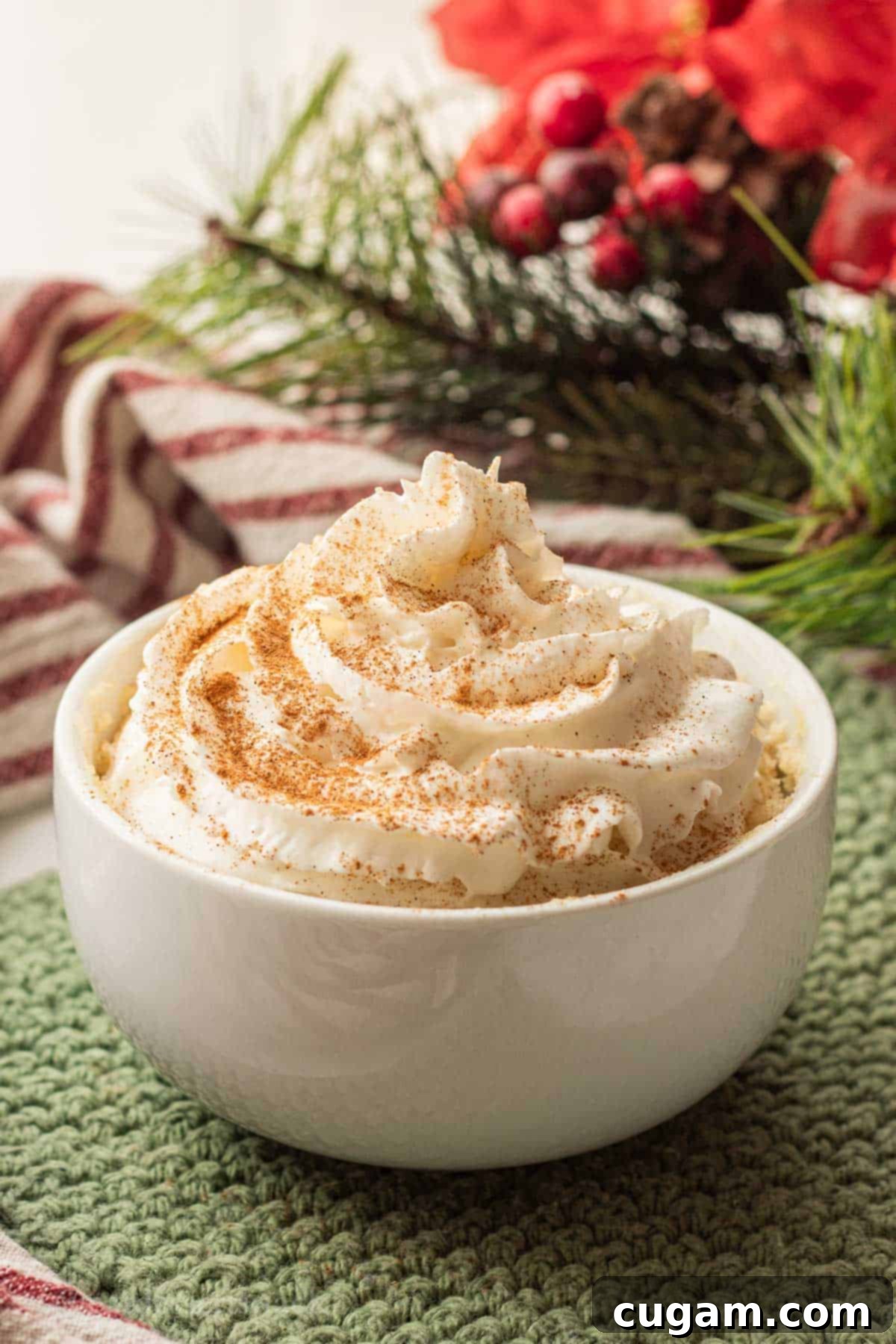 Freshly microwaved eggnog mug cake, perfectly cooked and risen.
