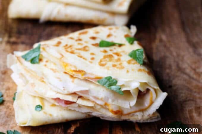 A single, perfectly golden French ham and cheese crepe, ready to be enjoyed as a savory meal