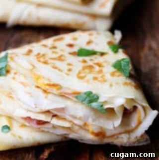 Ham and Cheese Crepes A French Street Food Classic 2 A stack of golden Ham and Cheese Crepes, a classic French savory street food, perfect for any meal.