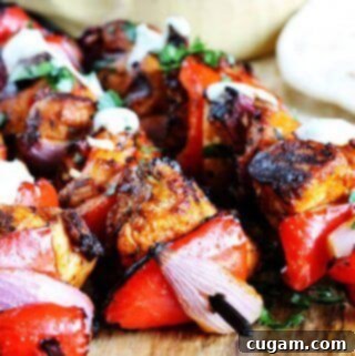 Perfectly grilled Mediterranean Chicken Kebabs with a side of creamy garlic yogurt sauce.