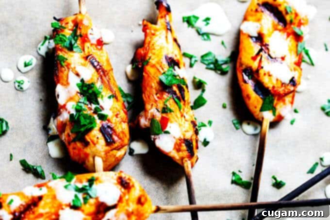 Honey Harissa Chicken Skewers, glazed and grilled to perfection, served with a refreshing garlic mint dipping sauce.