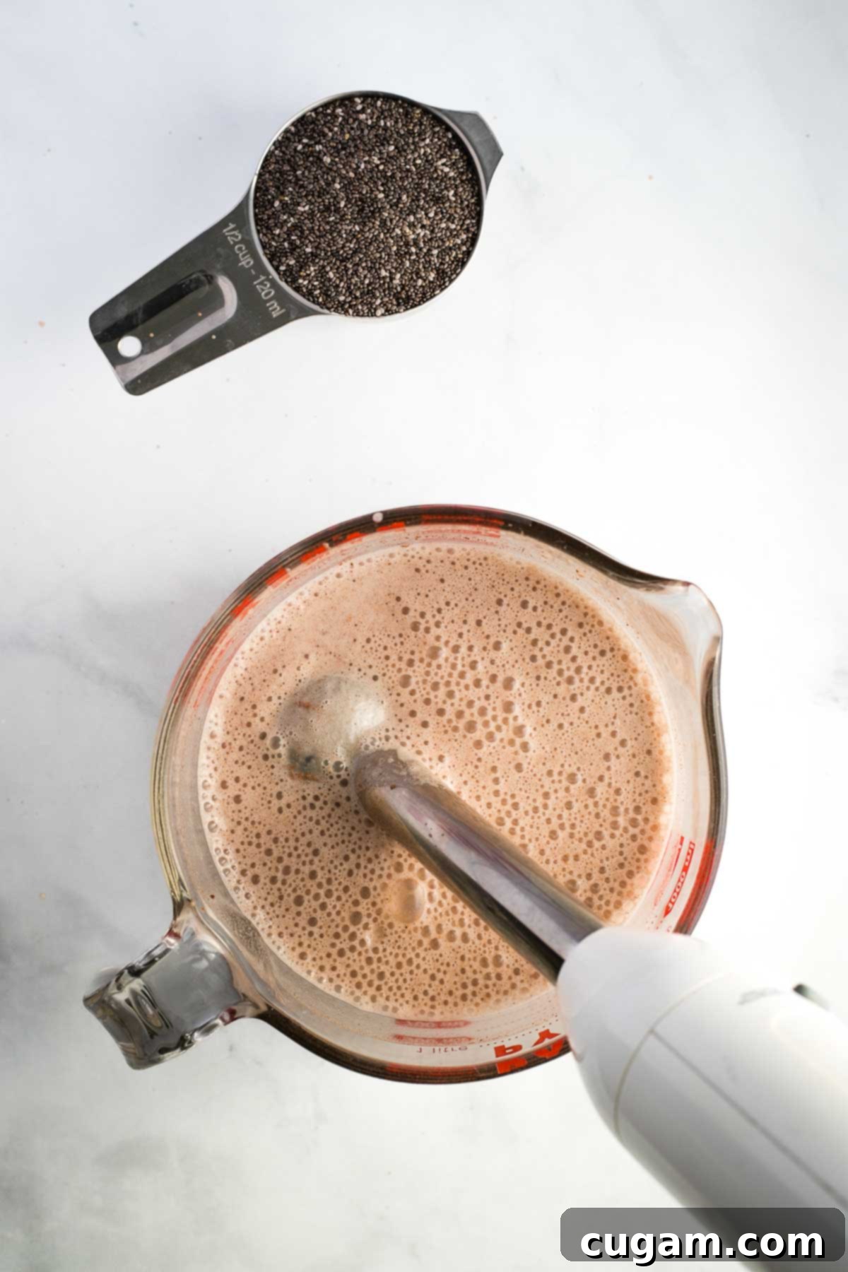 Making vegan chocolate milk with an immersion blender to become chia pudding.