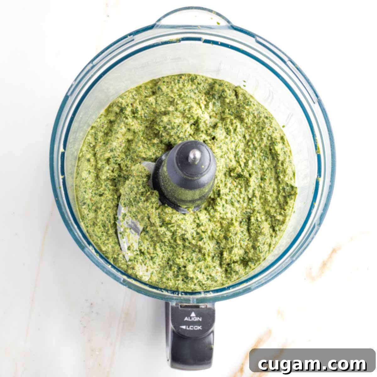 Vegan Arugula Walnut Pesto 6 Food processor bowl with creamy, bright green pesto.