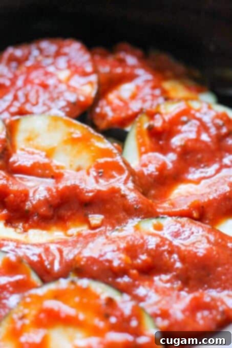 More marinara sauce added to the slow cooker