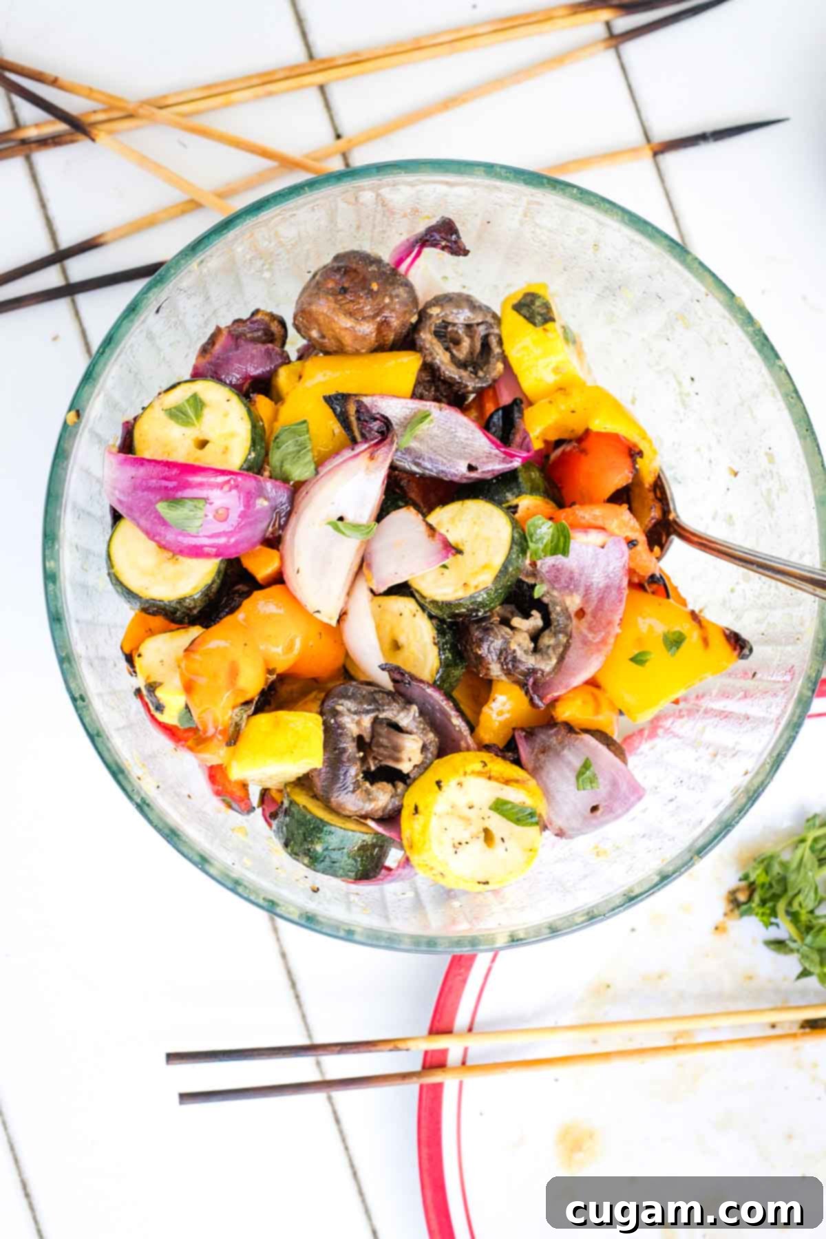 Mediterranean Harvest Skewers 12 Grilled vegetables taken off their skewers and placed into a bowl.
