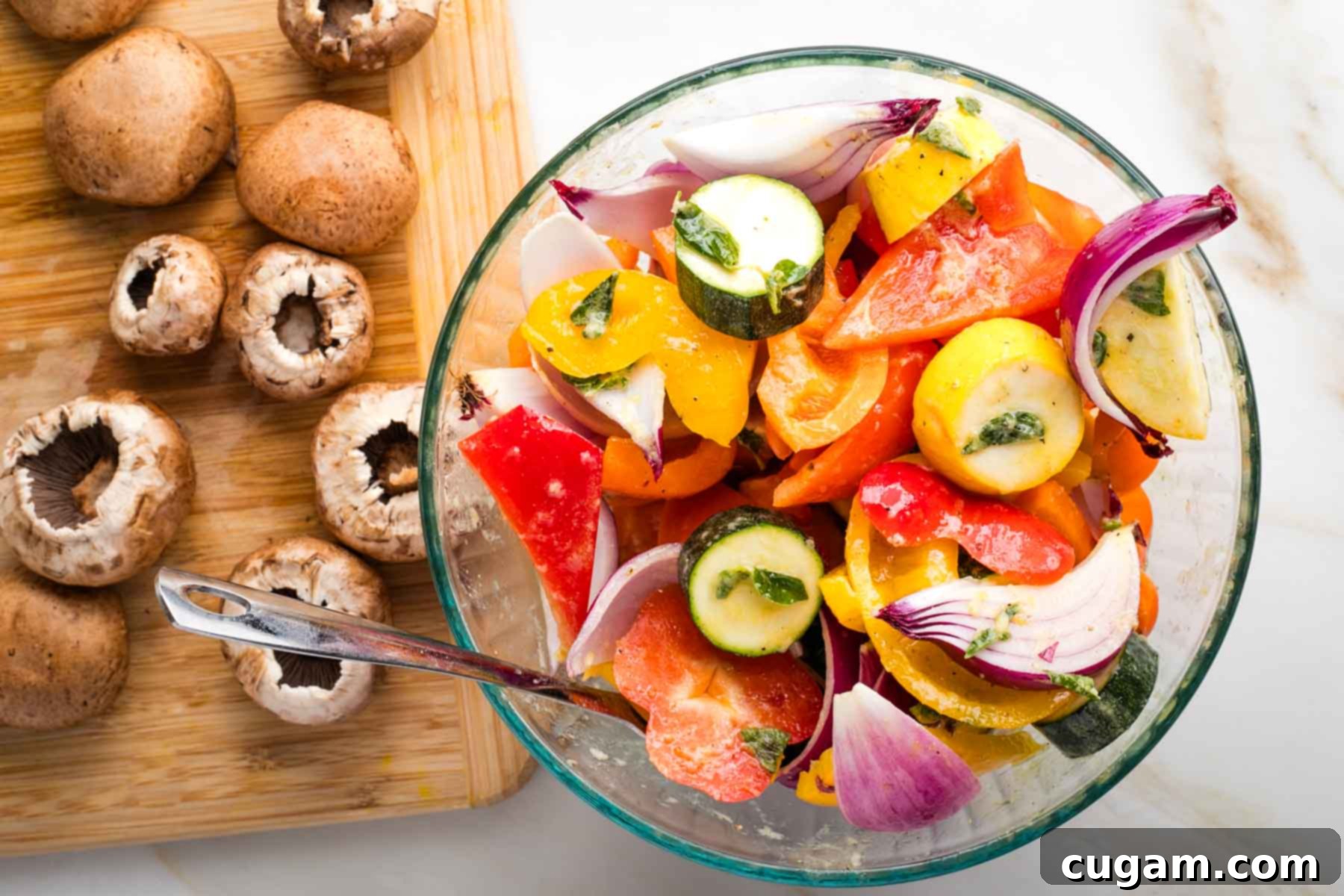 Mediterranean Harvest Skewers 6 Bowl of cut up veggies marinating and a cutting board with mushrooms off to the side.