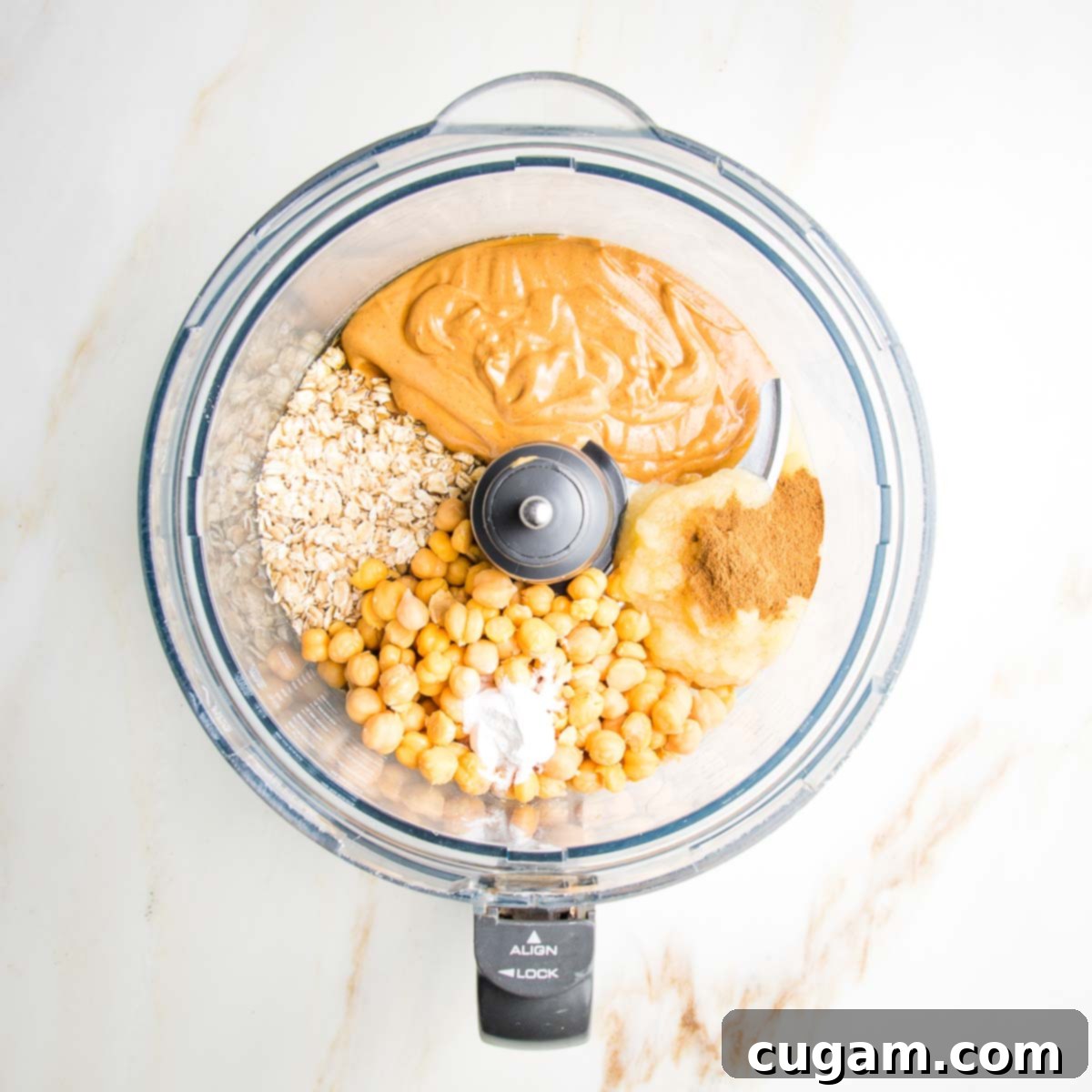 Delicious Vegan Gluten-Free Chocolate Chunk Skillet Cookie 5 Drained chickpeas, rolled oats, peanut butter, and cinnamon in the bowl of a food processor, ready to be blended.