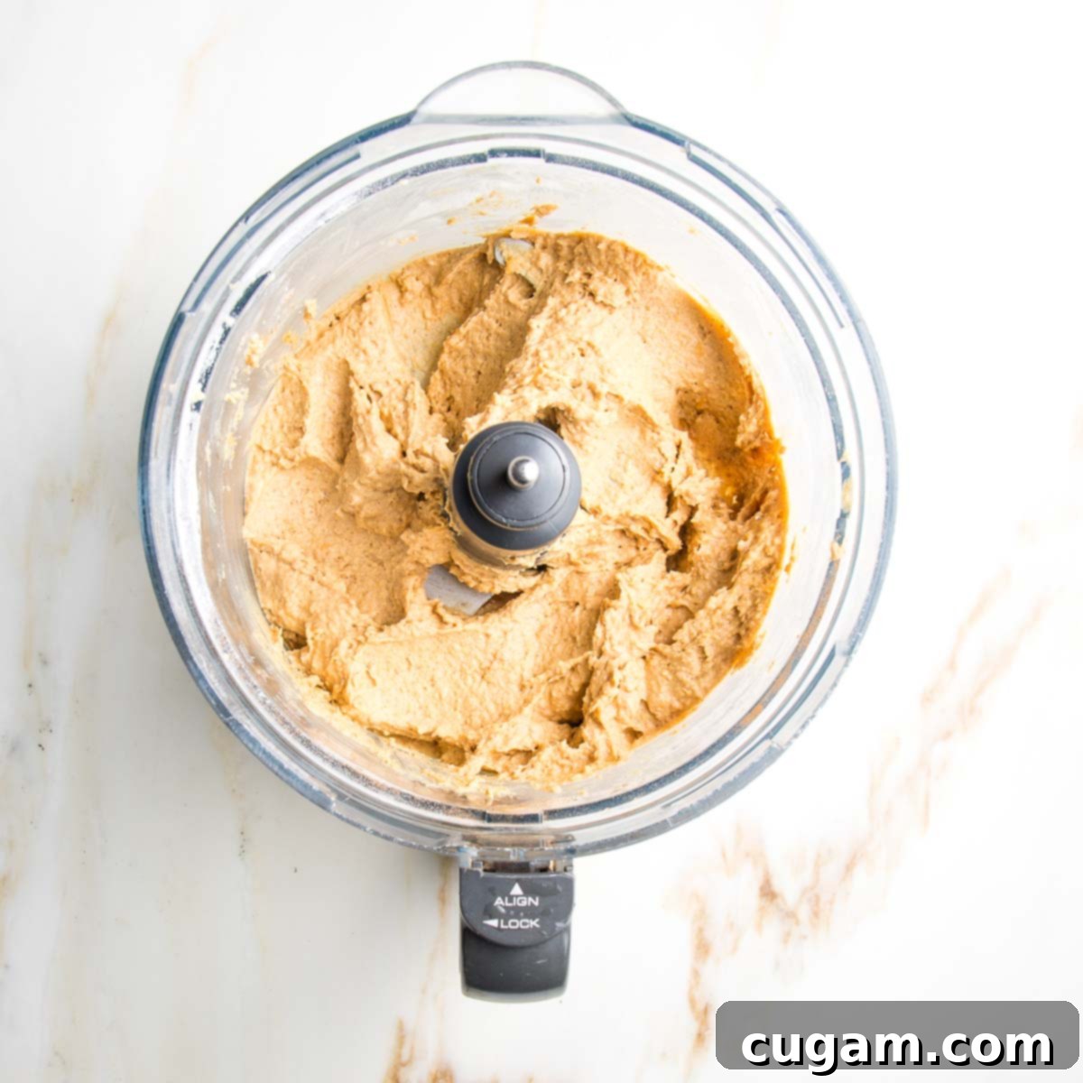 Delicious Vegan Gluten-Free Chocolate Chunk Skillet Cookie 6 Smooth and creamy cookie dough batter in the bowl of a food processor after blending.