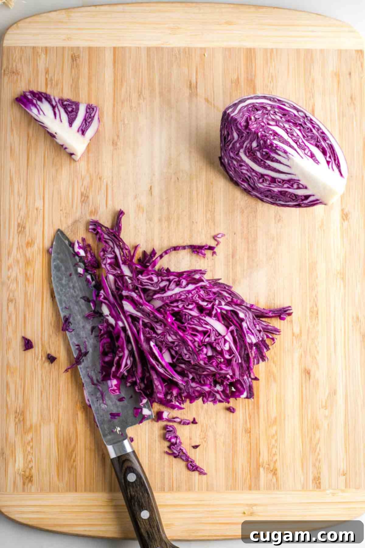 Quartered red cabbage with the core cut out and ¼ is thinly sliced. 