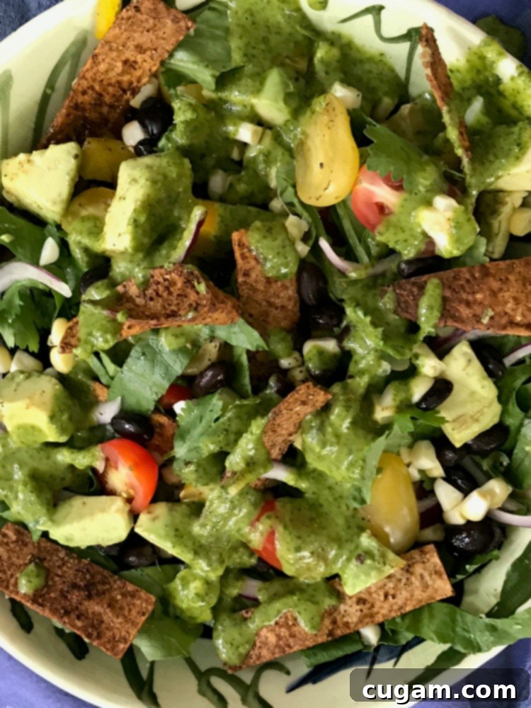 Vegan taco salad topped with vibrant cilantro dressing