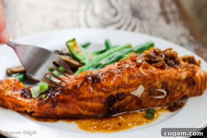 Close-up of grilled salmon with homemade teriyaki glaze, perfectly cooked in foil.