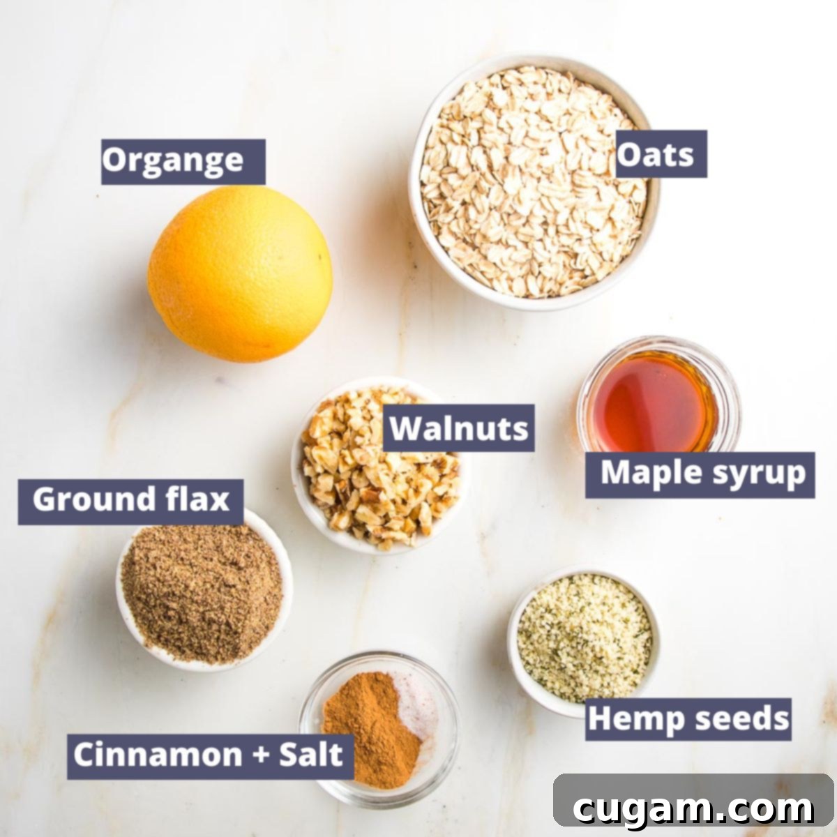 Labeled ingredients for fruit crisp topping: orange, oats, flax, walnuts, hemp seeds, cinnamon and maple syrup.
