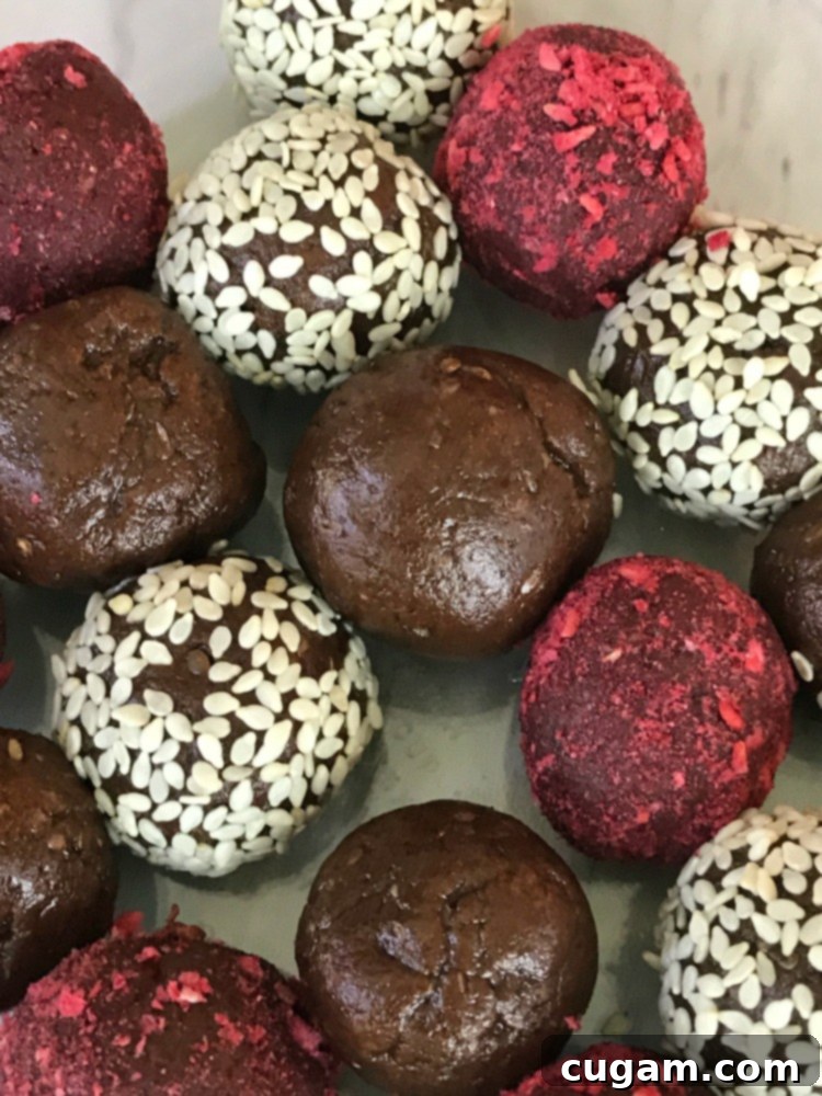 Chocolate Halva bliss balls. Some coated with freeze dried raspberries and others with sesame seeds.