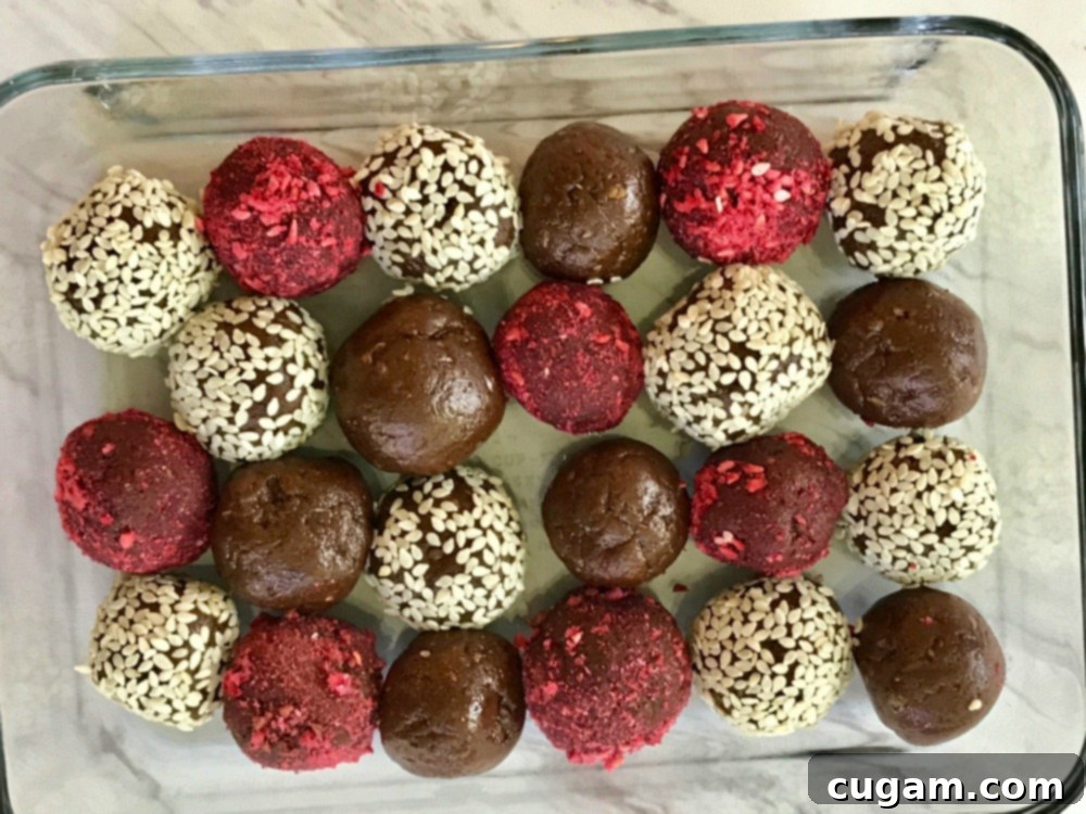 Various Halva Bliss Balls in a container, ready for storage.